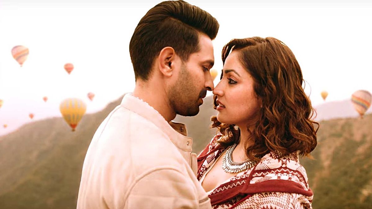 Couple embracing with hot air balloons.